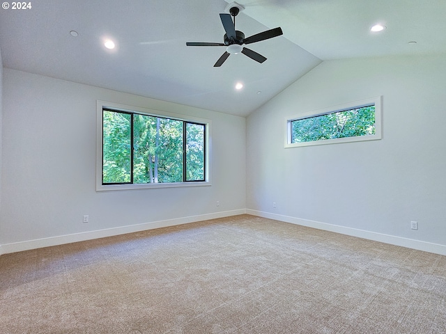 carpeted spare room with vaulted ceiling and ceiling fan