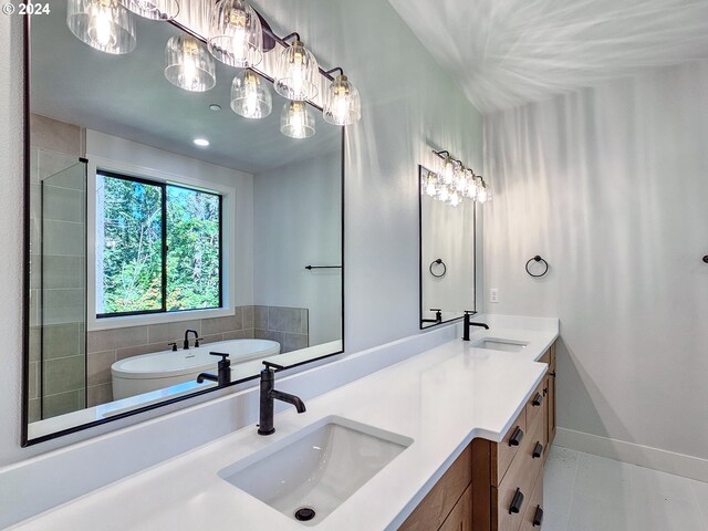 bathroom with tile patterned flooring, vanity, and a bathing tub