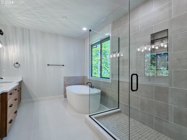 bathroom with independent shower and bath, vanity, and tile patterned floors