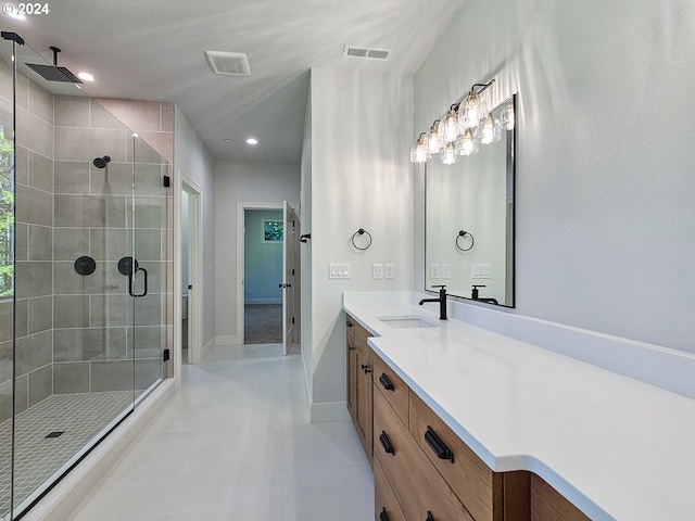 bathroom with vanity, a shower with shower door, and tile patterned flooring