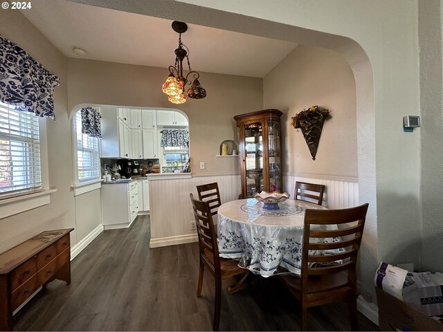 dining area featuring dark hardwood / wood-style floors and a chandelier