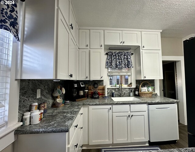 kitchen with dishwasher, backsplash, dark wood-type flooring, white cabinets, and sink