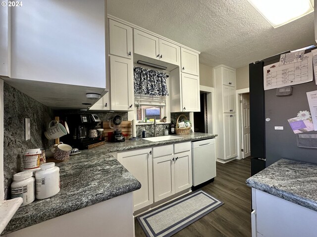 kitchen featuring dark hardwood / wood-style flooring, a textured ceiling, sink, dishwasher, and white cabinetry