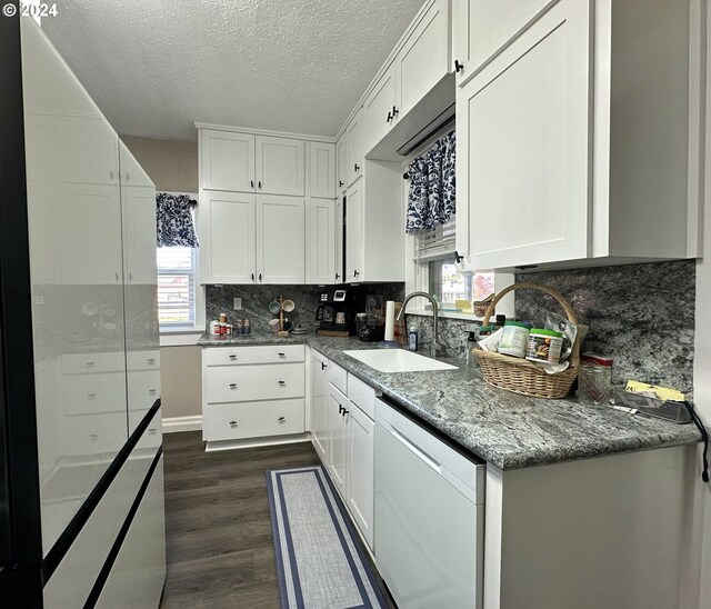 kitchen with dishwasher, white cabinets, a healthy amount of sunlight, and sink