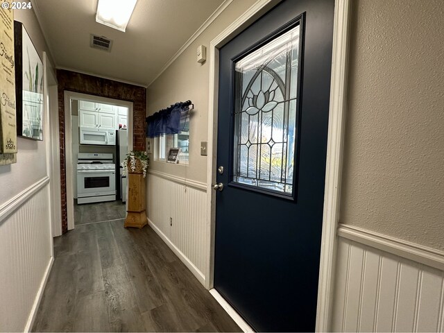 entryway with crown molding and dark wood-type flooring