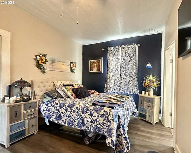 bedroom with dark hardwood / wood-style flooring