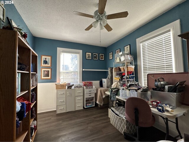 office featuring ceiling fan, dark wood-type flooring, and a textured ceiling