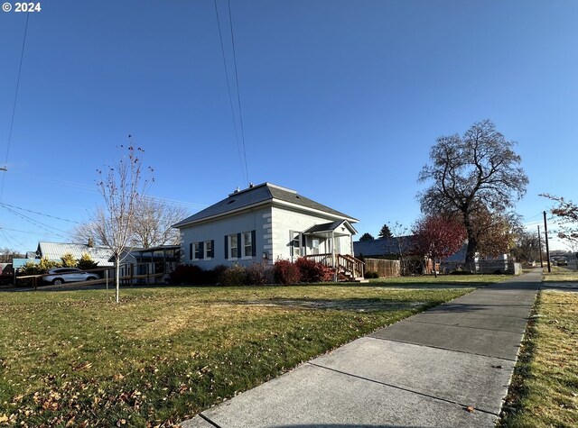 view of property exterior featuring a lawn