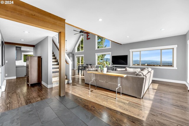 living room with ceiling fan, dark wood-type flooring, and high vaulted ceiling