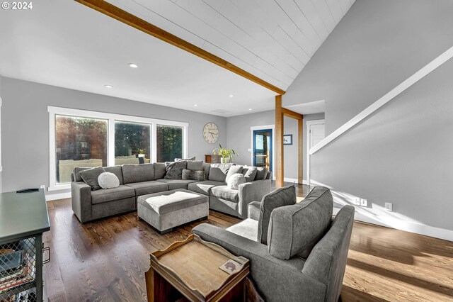 living room featuring dark hardwood / wood-style flooring and high vaulted ceiling