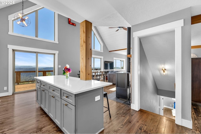 40700 NE Skye View Dr, Washougal, WA 98671 - kitchen featuring gray cabinetry, dark wood finished floors, a kitchen bar, a kitchen island, and a ceiling fan