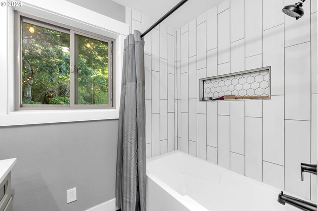 bathroom with shower / bath combo with shower curtain and vanity