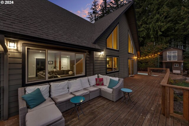 deck at dusk with an outdoor hangout area