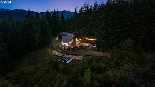 aerial view at dusk featuring a mountain view