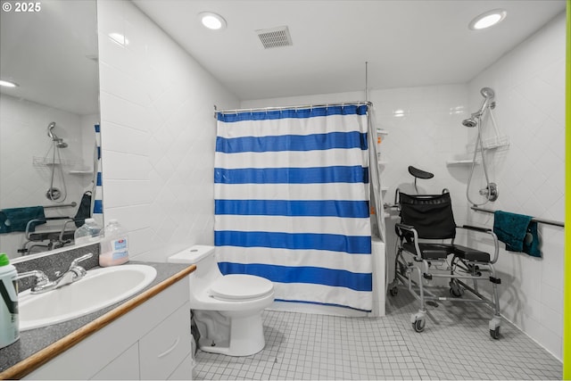 bathroom featuring walk in shower, tile patterned flooring, toilet, vanity, and tile walls