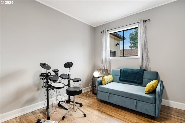 sitting room featuring hardwood / wood-style floors and crown molding