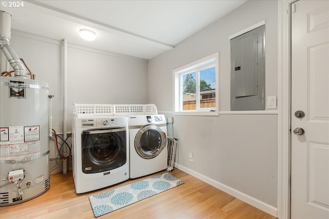 laundry room with hardwood / wood-style floors, independent washer and dryer, electric panel, and water heater