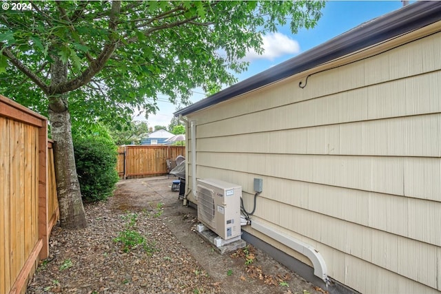 view of side of home featuring ac unit