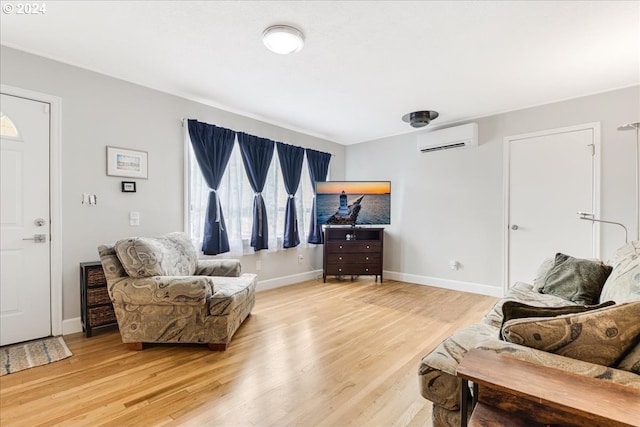 living room with an AC wall unit and hardwood / wood-style floors