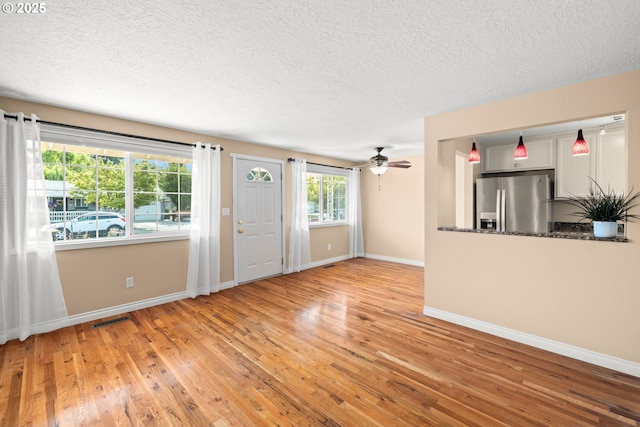 1499 Walton Way, Woodburn, OR 97071 - unfurnished living room with a textured ceiling, light wood finished floors, and ceiling fan