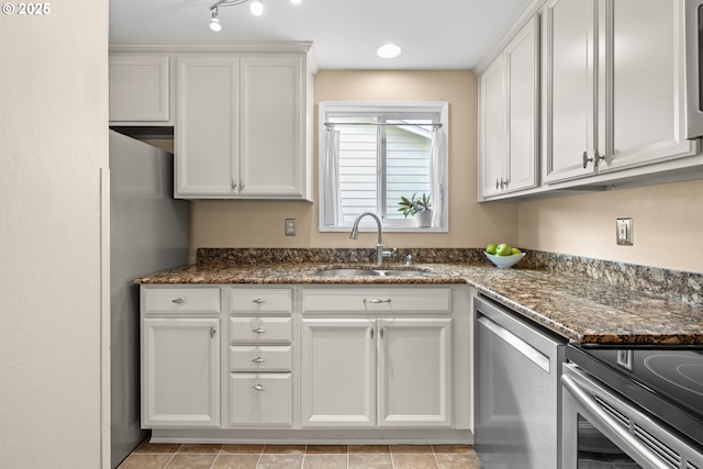 1499 Walton Way, Woodburn, OR 97071 - kitchen with stainless steel dishwasher, white cabinets, and dark stone countertops