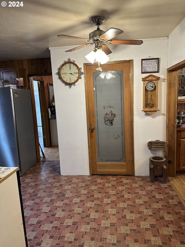 136350 Main St, Crescent, OR 97733 - foyer entrance featuring a ceiling fan, wooden walls, and brick patterned flooring