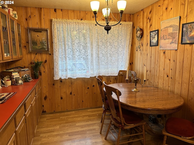 136350 Main St, Crescent, OR 97733 - dining space with a chandelier, wood walls, and light wood-style flooring