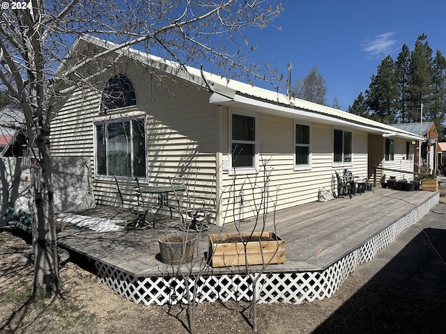 back of house with a wooden deck