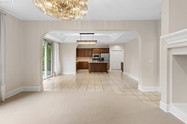 interior space with light carpet, a raised ceiling, and a chandelier