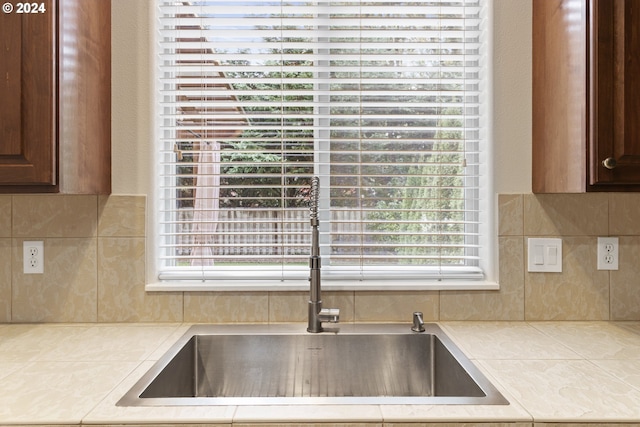 kitchen featuring tasteful backsplash and sink