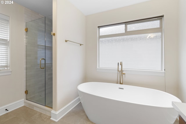 bathroom with vanity, shower with separate bathtub, and tile patterned flooring