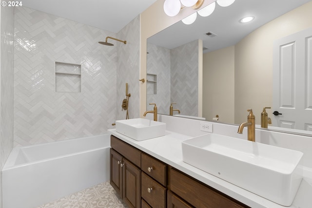 bathroom featuring vanity and tiled shower / bath combo