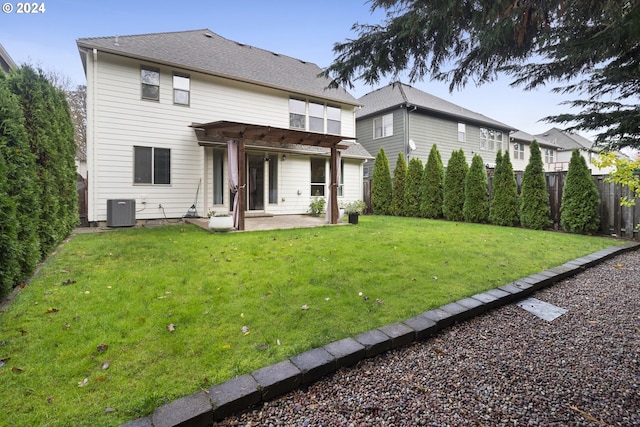 back of house featuring a lawn, a patio area, central air condition unit, and a pergola