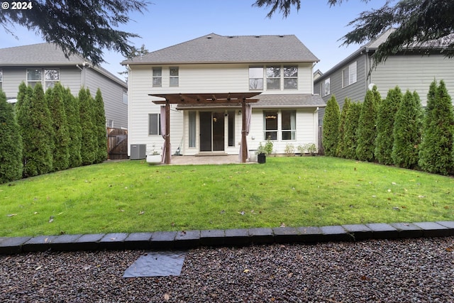 back of property with a patio, a yard, central AC, and a pergola