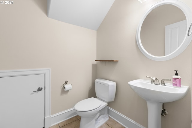 bathroom featuring lofted ceiling, tile patterned floors, and toilet