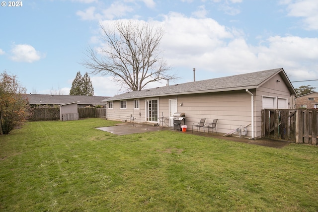 back of house featuring a yard, a storage shed, and a patio area