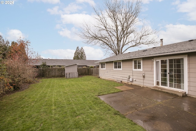 view of yard with a patio and a storage shed