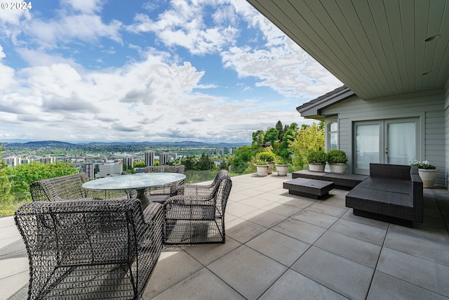 view of patio / terrace with a mountain view and french doors