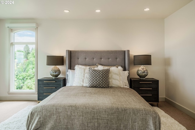 bedroom with carpet floors and multiple windows