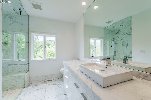 bathroom featuring vanity, toilet, and an enclosed shower