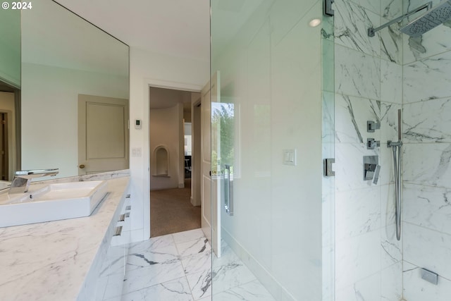 bathroom featuring vanity and a shower with shower door