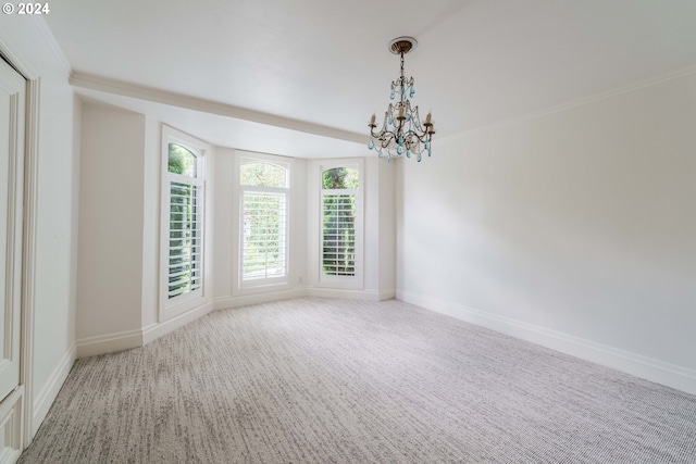 empty room with carpet floors and a notable chandelier