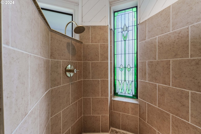 bathroom with tiled shower