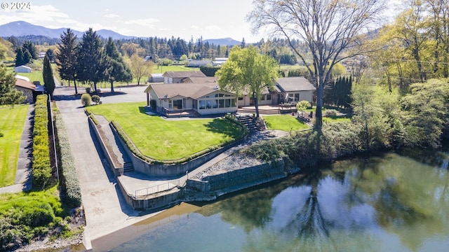 birds eye view of property with a water and mountain view