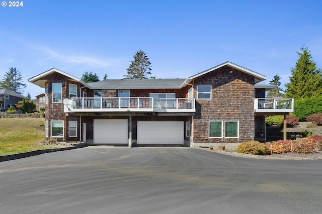 view of front facade with a balcony and a garage