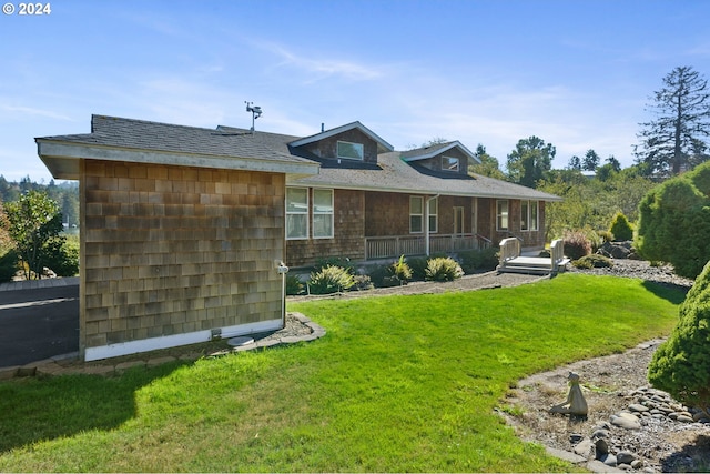 back of property featuring a porch and a lawn