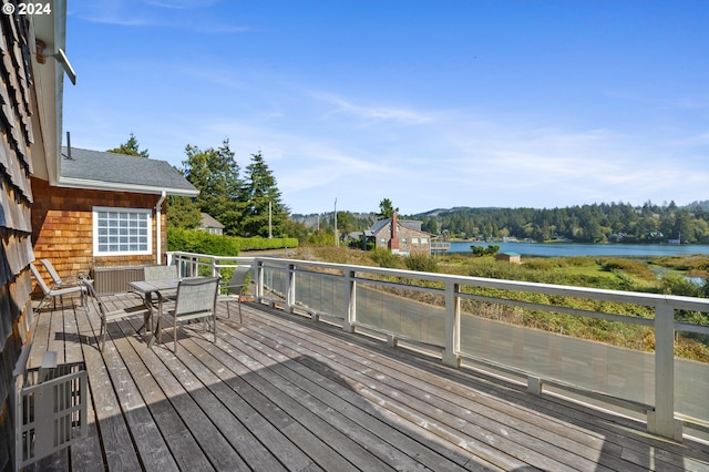 wooden terrace featuring a water view