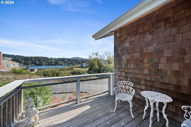 wooden terrace with a water view