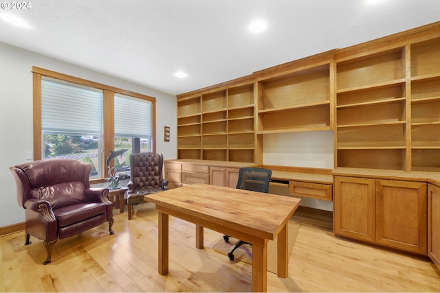 office area featuring light wood-type flooring and built in desk