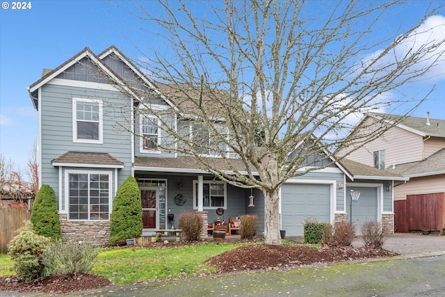 view of front of home featuring a porch and a garage